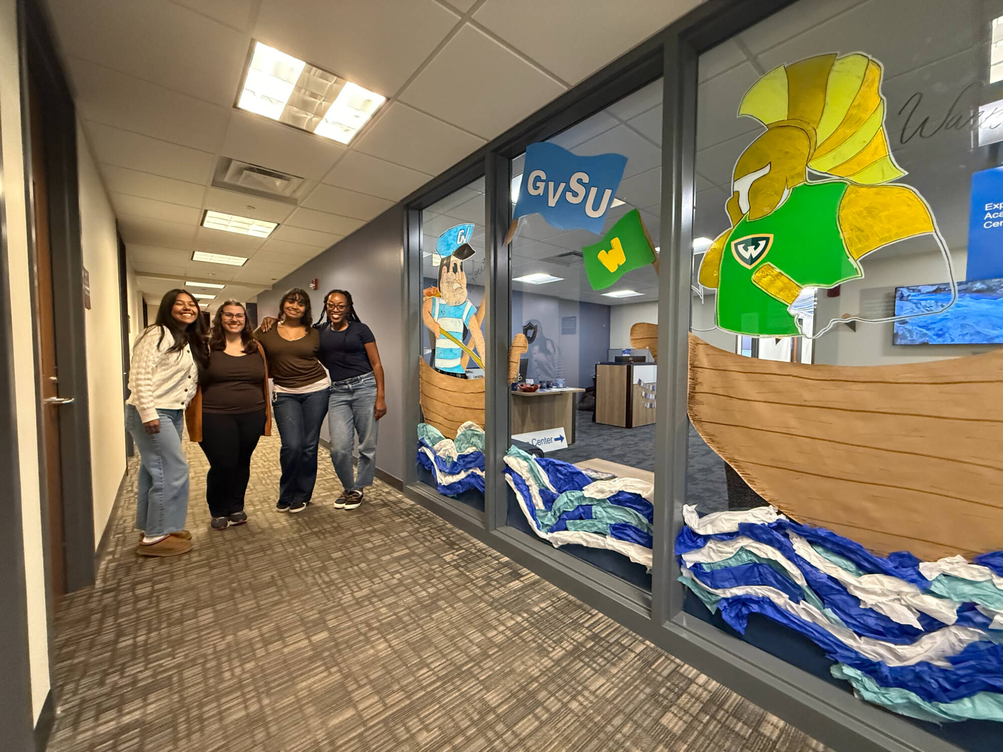 Exploratory Advising Center student colleagues posing with their homecoming decor
